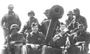 Happy ex-POWs pose with one of Patton's tank crews (click for larger image)